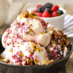 cast iron skillet full of berry crisp ice cream