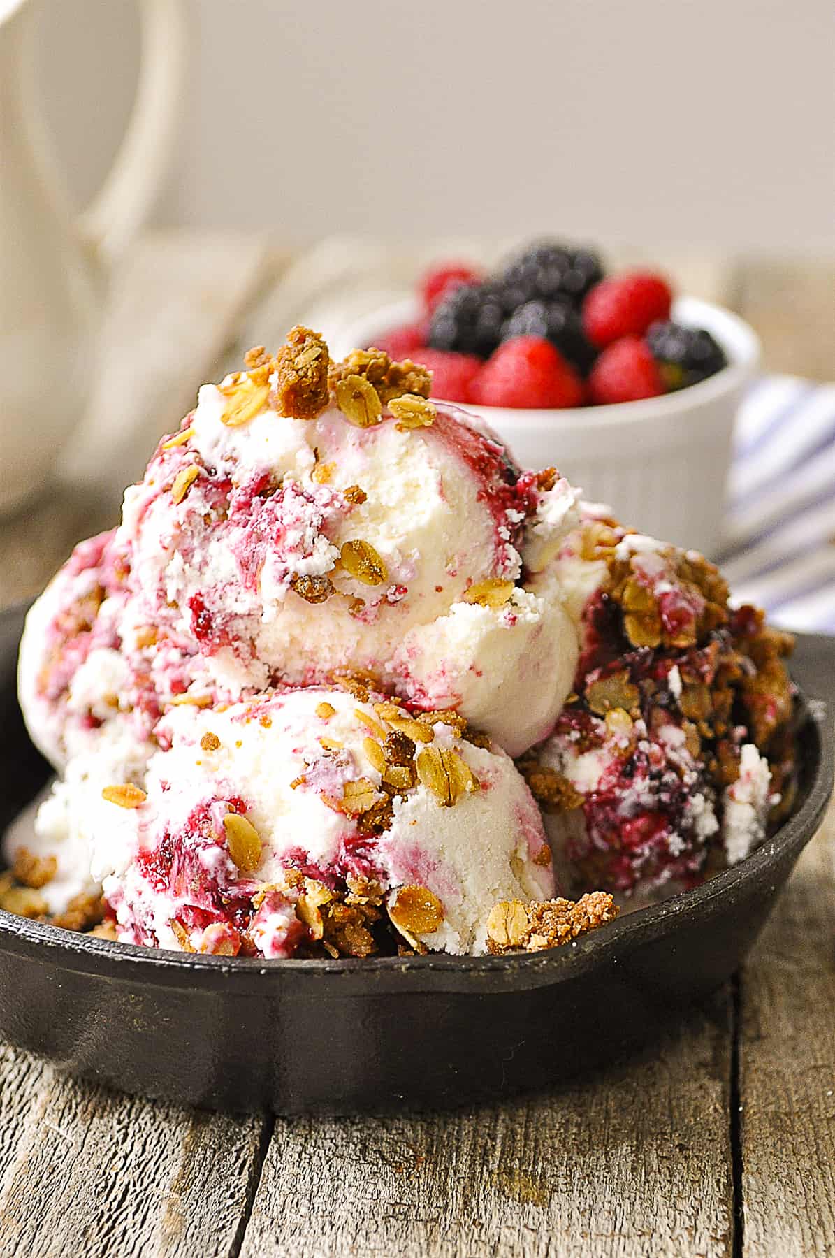 cast iron skillet full of berry crisp ice cream