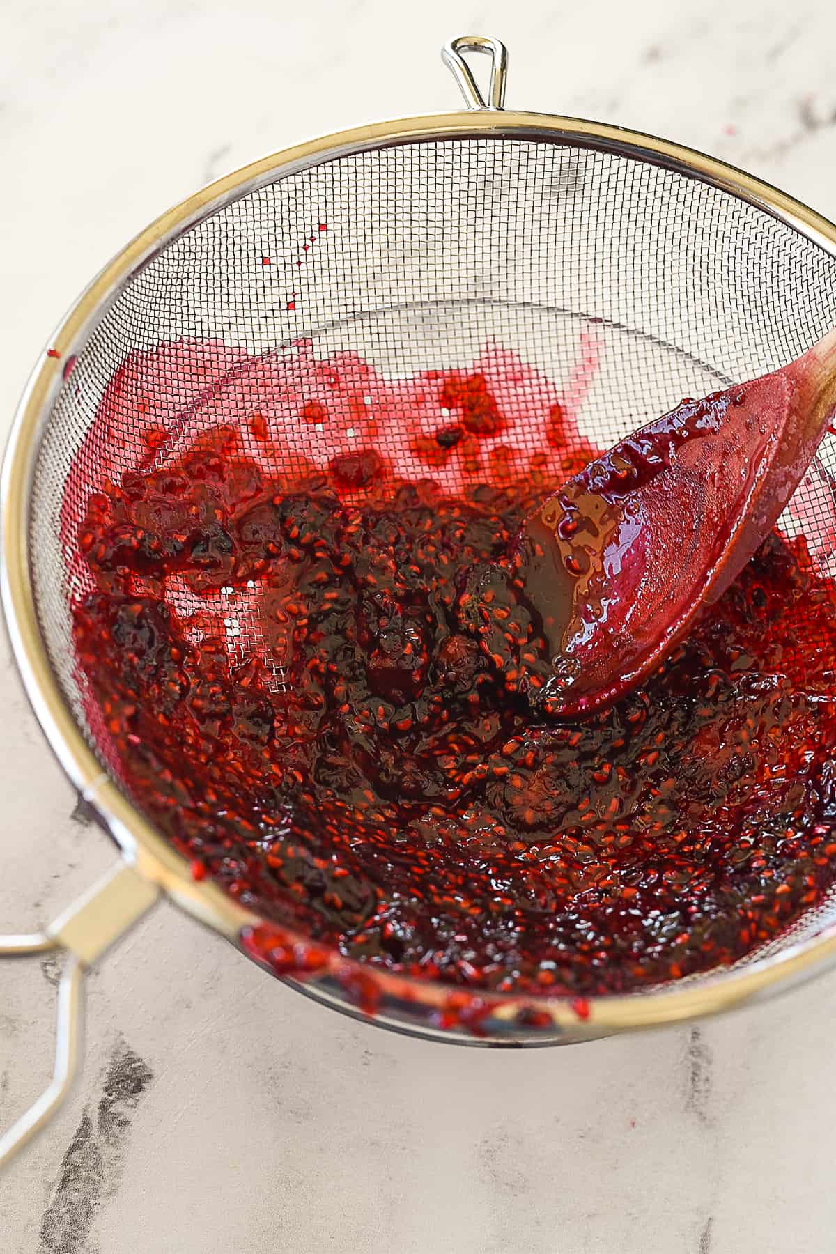 PUSHING BERRIES THRU STRAINER