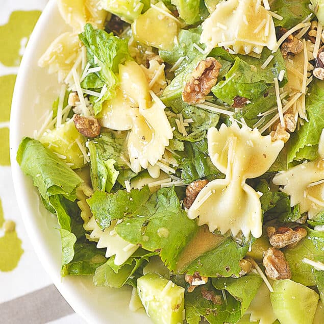 OVERHEAD SHOT OF CAESAR PASTA SALAD IN A WHITE BOWL