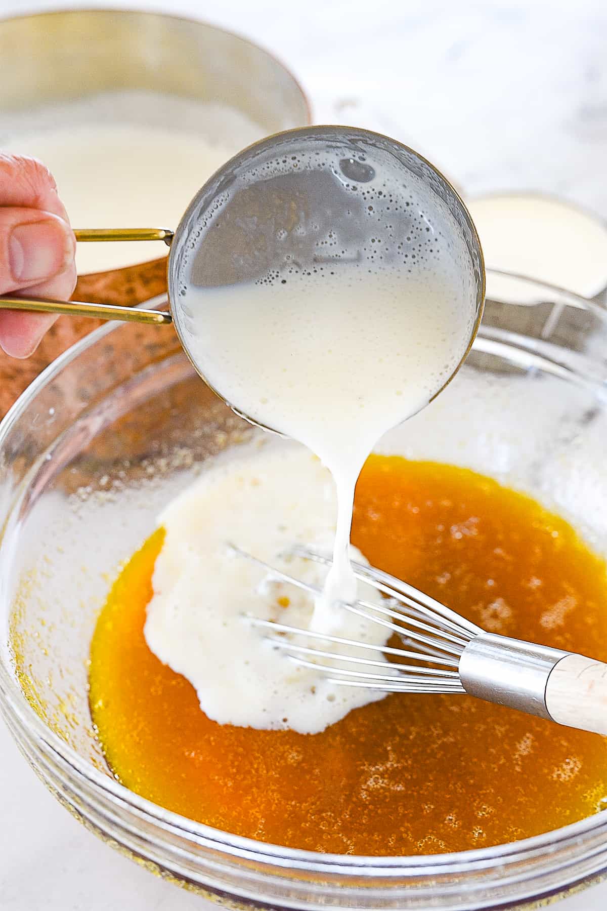 adding milk to bowl of maple syrup