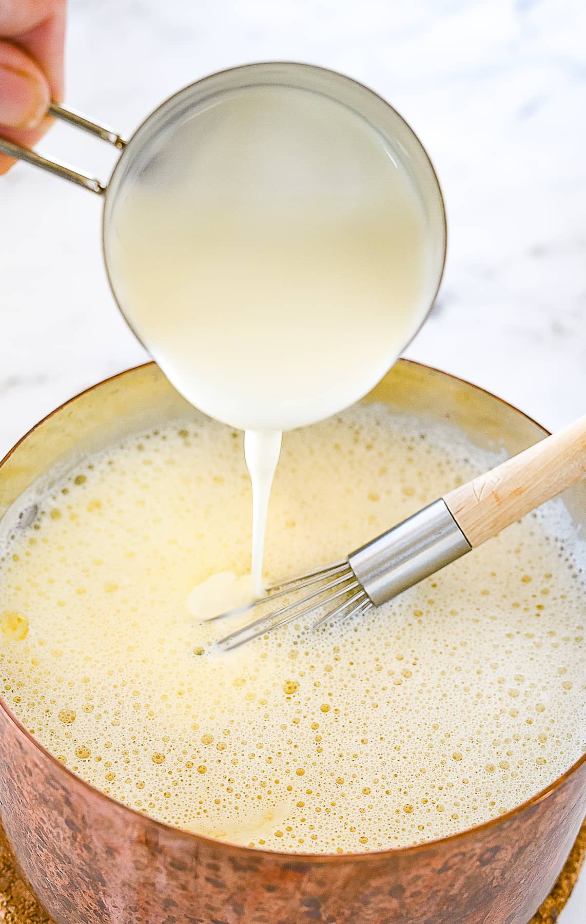 pouring cream into milk