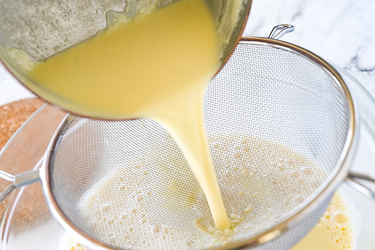 pouring milk through a sieve