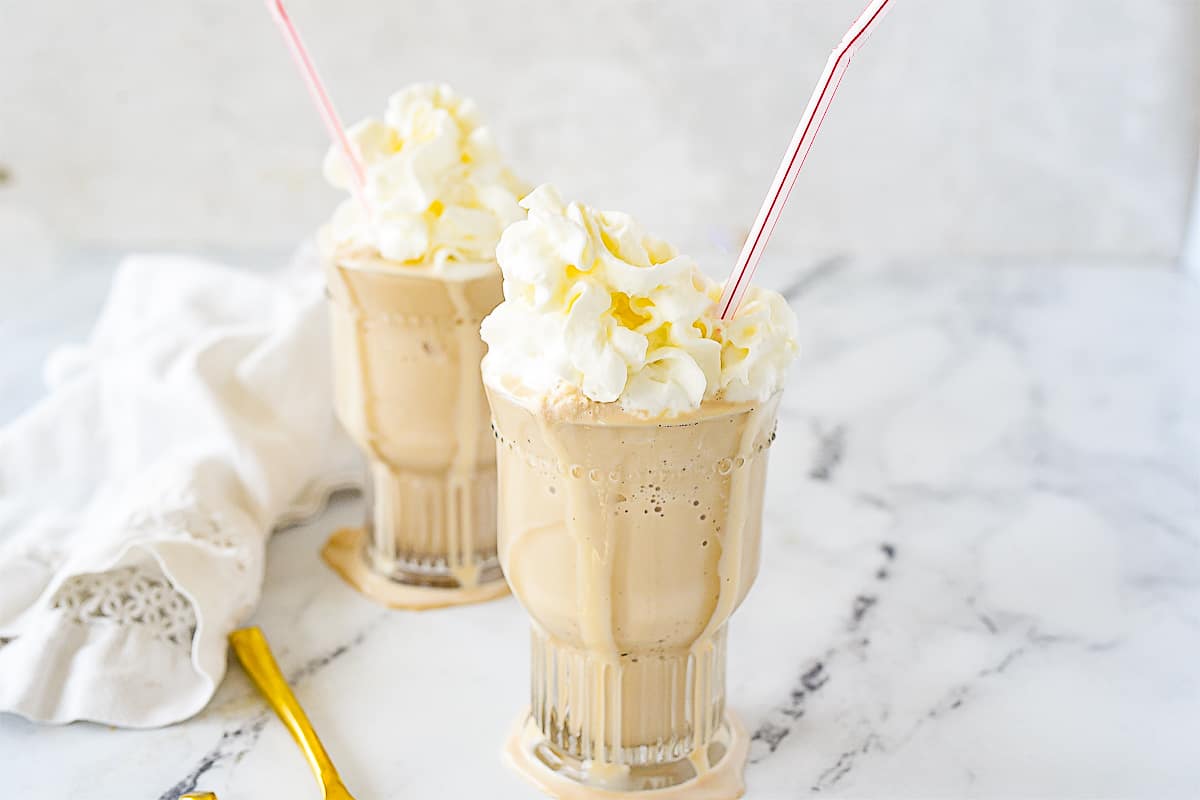 TWO ROOT BEER MILKSHAKES IN GLASSES