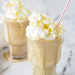 TWO ROOT BEER MILKSHAKES WITH STRAWS AND WHIPPED CREAM