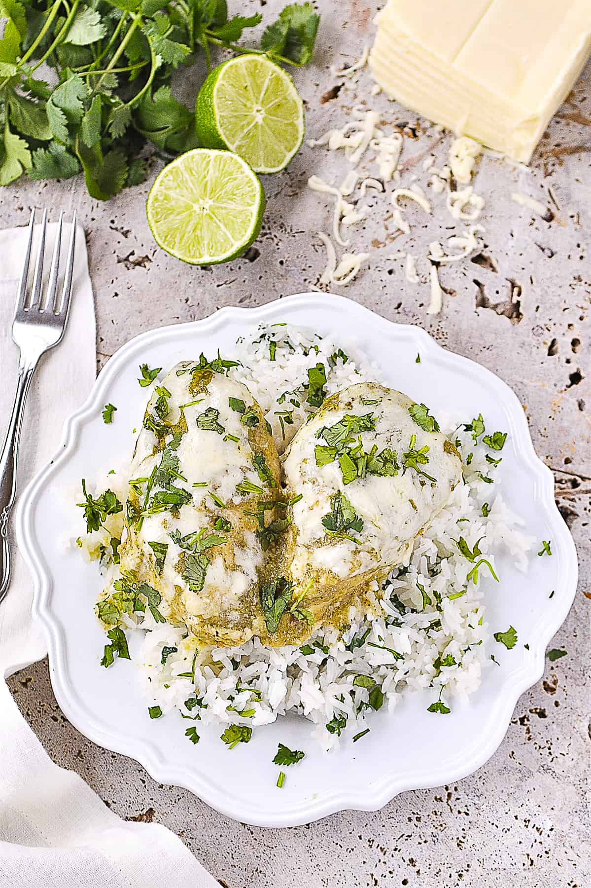 overhead shot of salsa verde chicken over rice on a plate