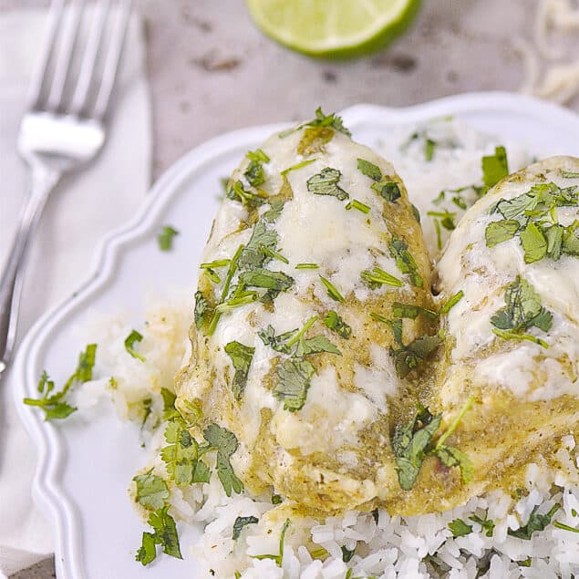 TWO salsa verde chicken breasts on a plate over rice