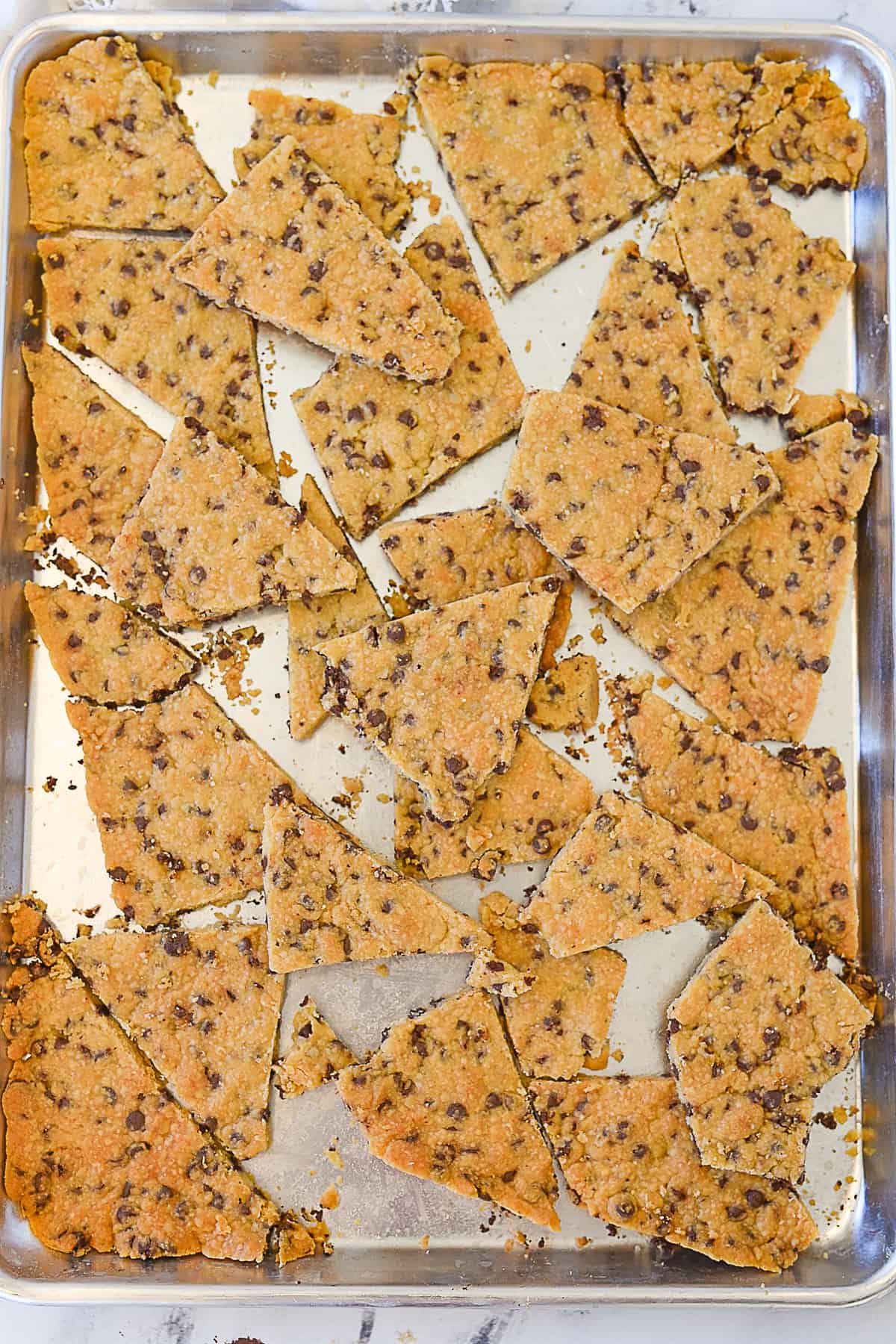 overhead shot of chocolate chip cookie brittle on baking sheet