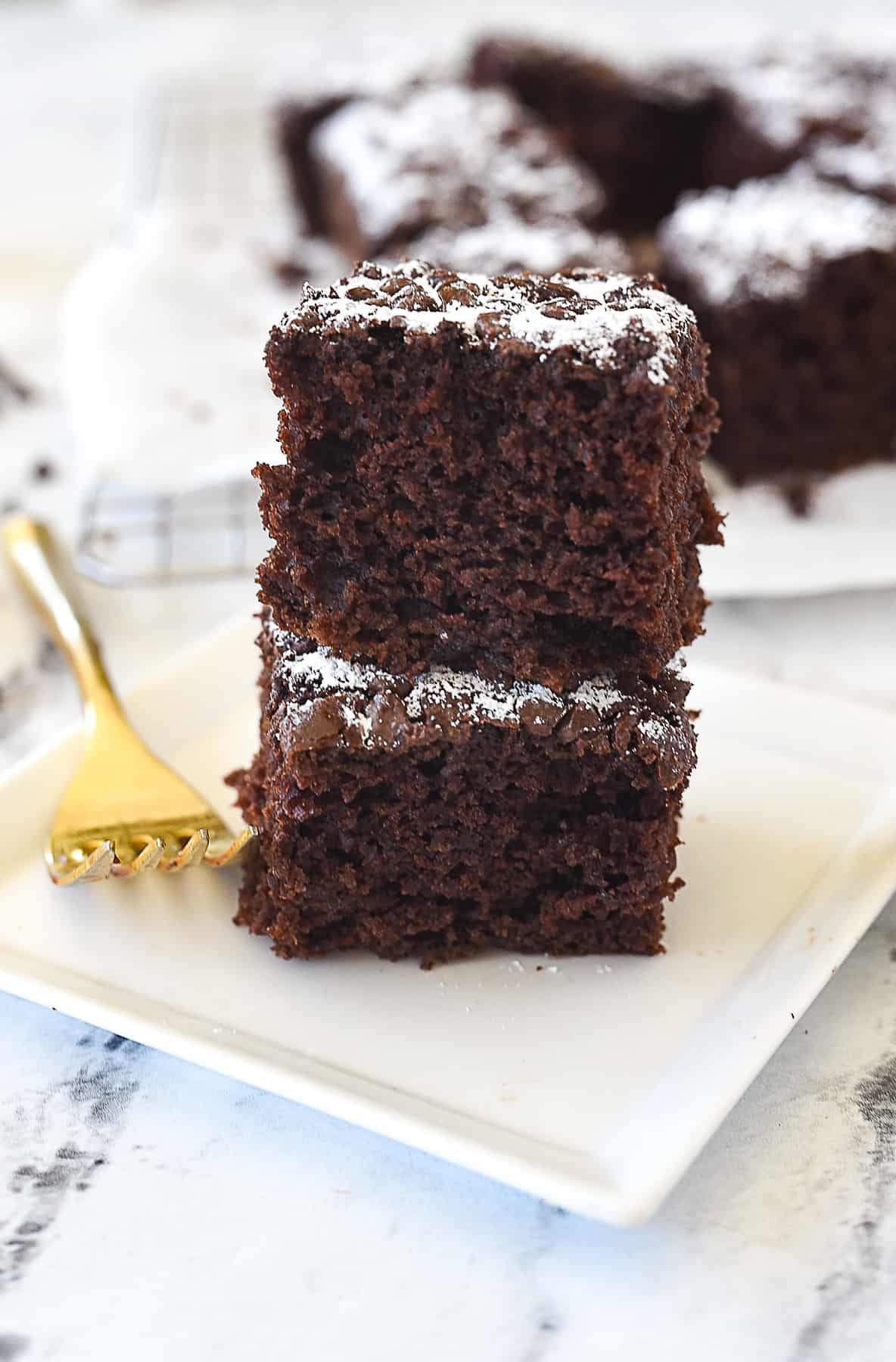 two pieces of chocolate cake stacked on top of each other