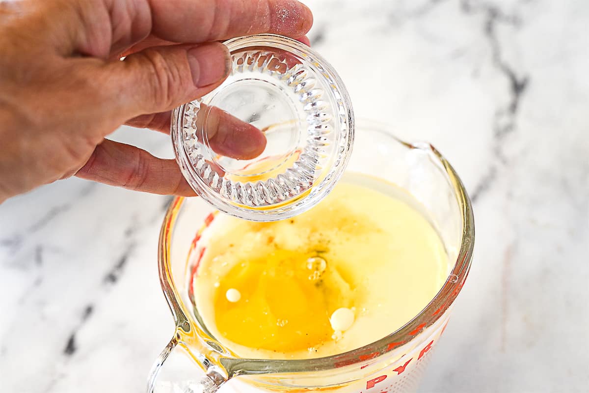 adding vinegar to milk mixture