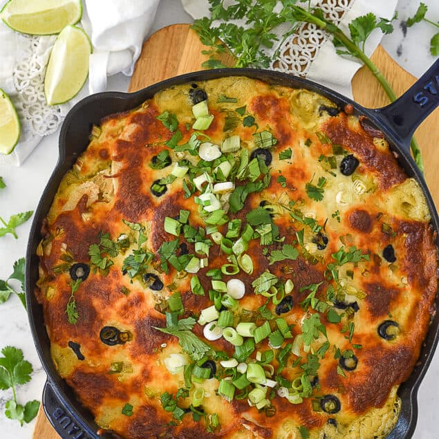 baked green chili chicken casserole in cast iron pan