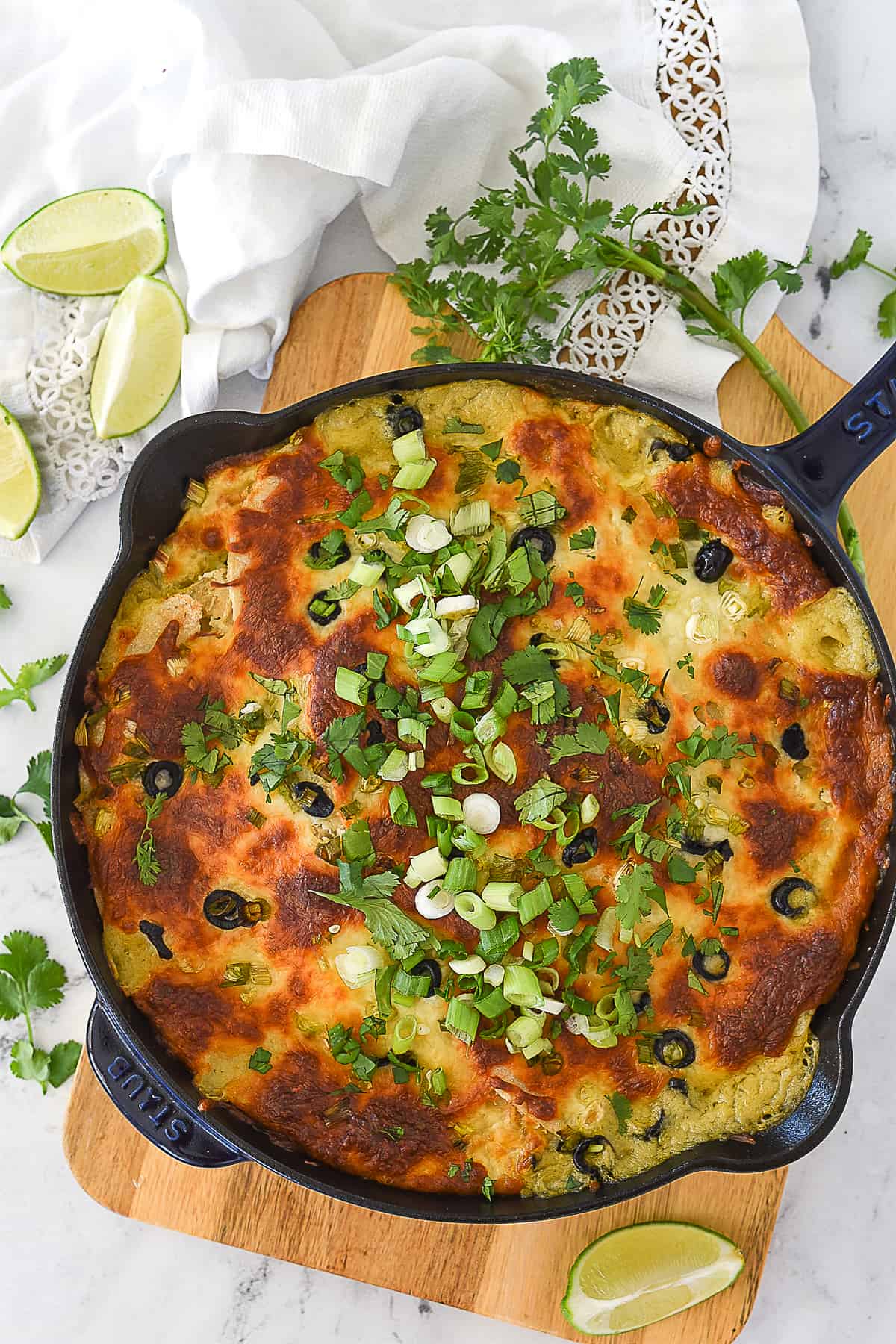 baked green chili chicken casserole in cast iron pan