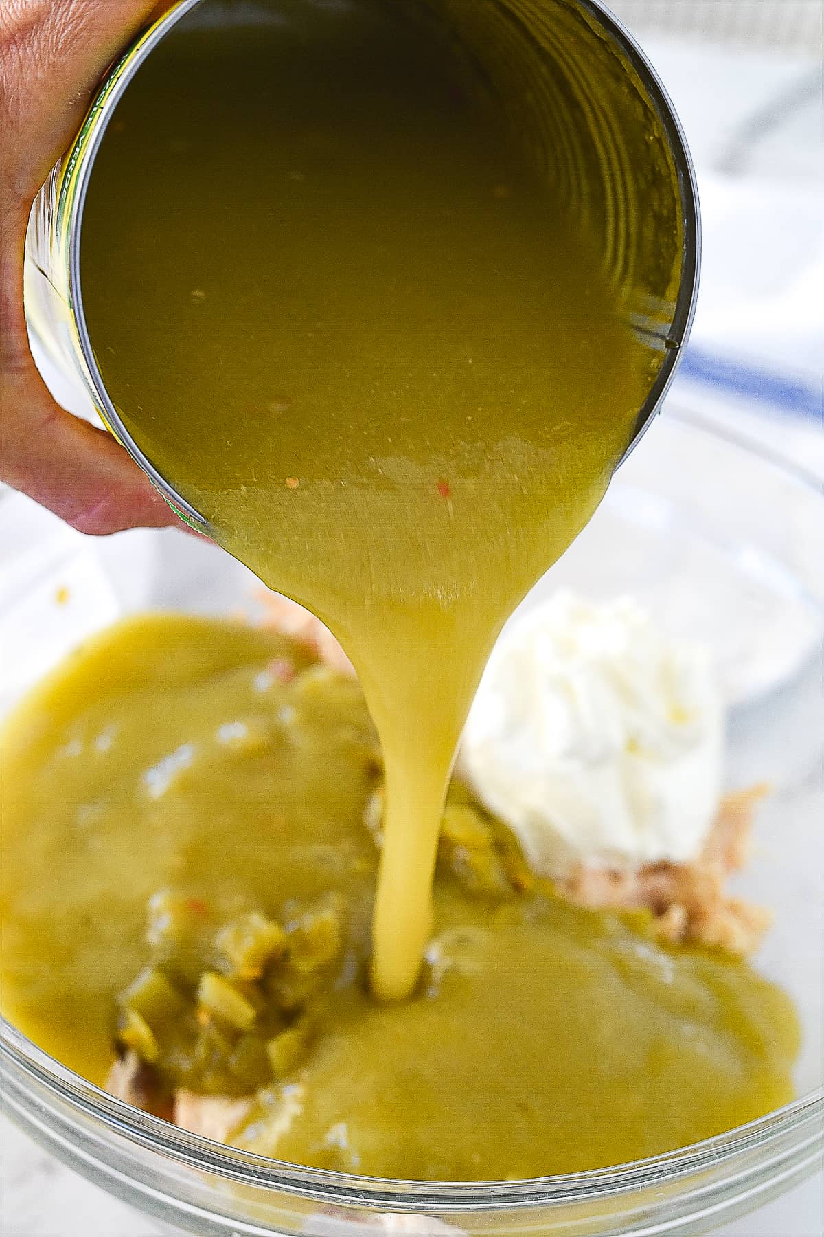 adding enchilada sauce to chicken