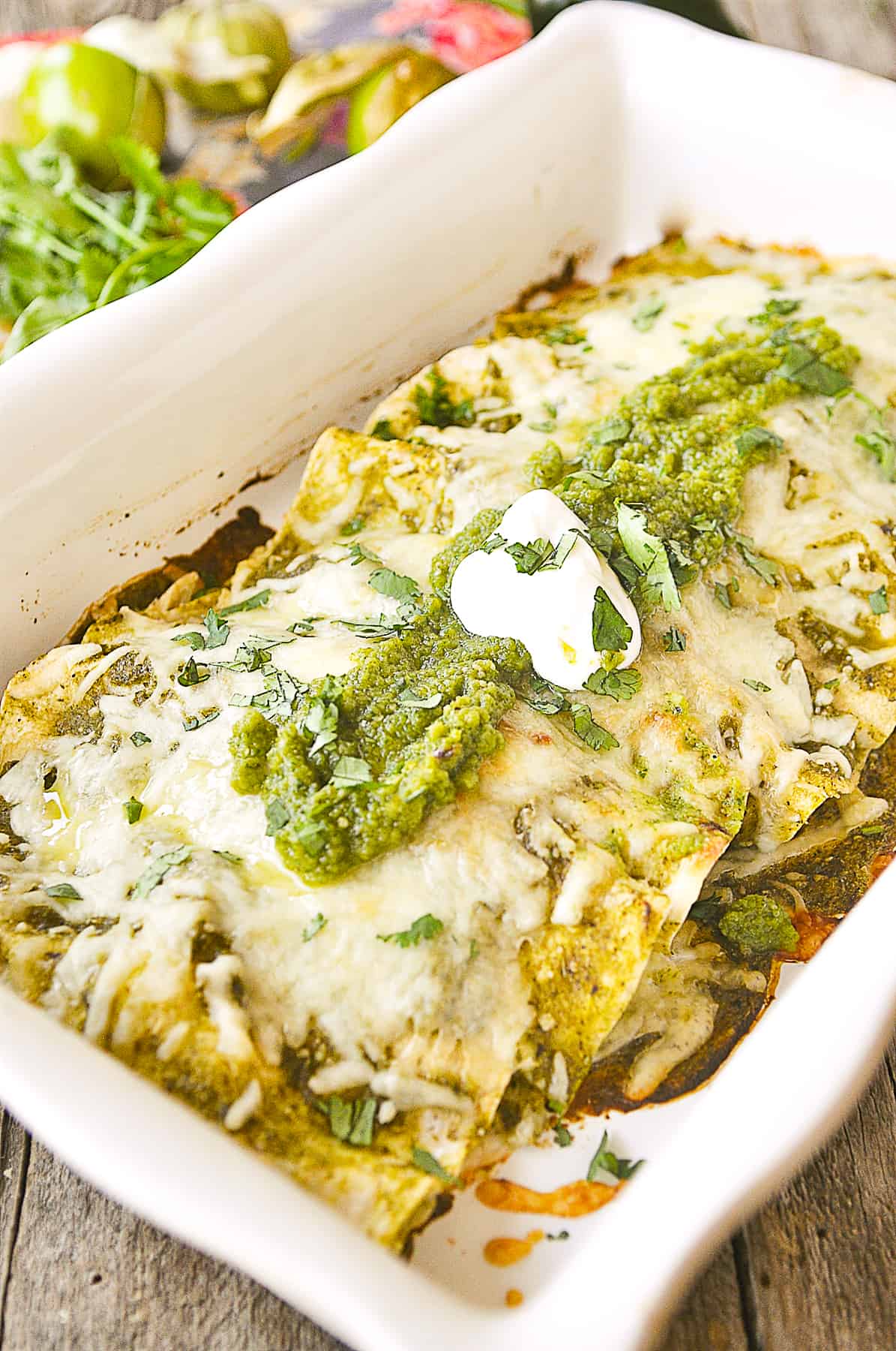 baked green chili enchiladas in a white pan