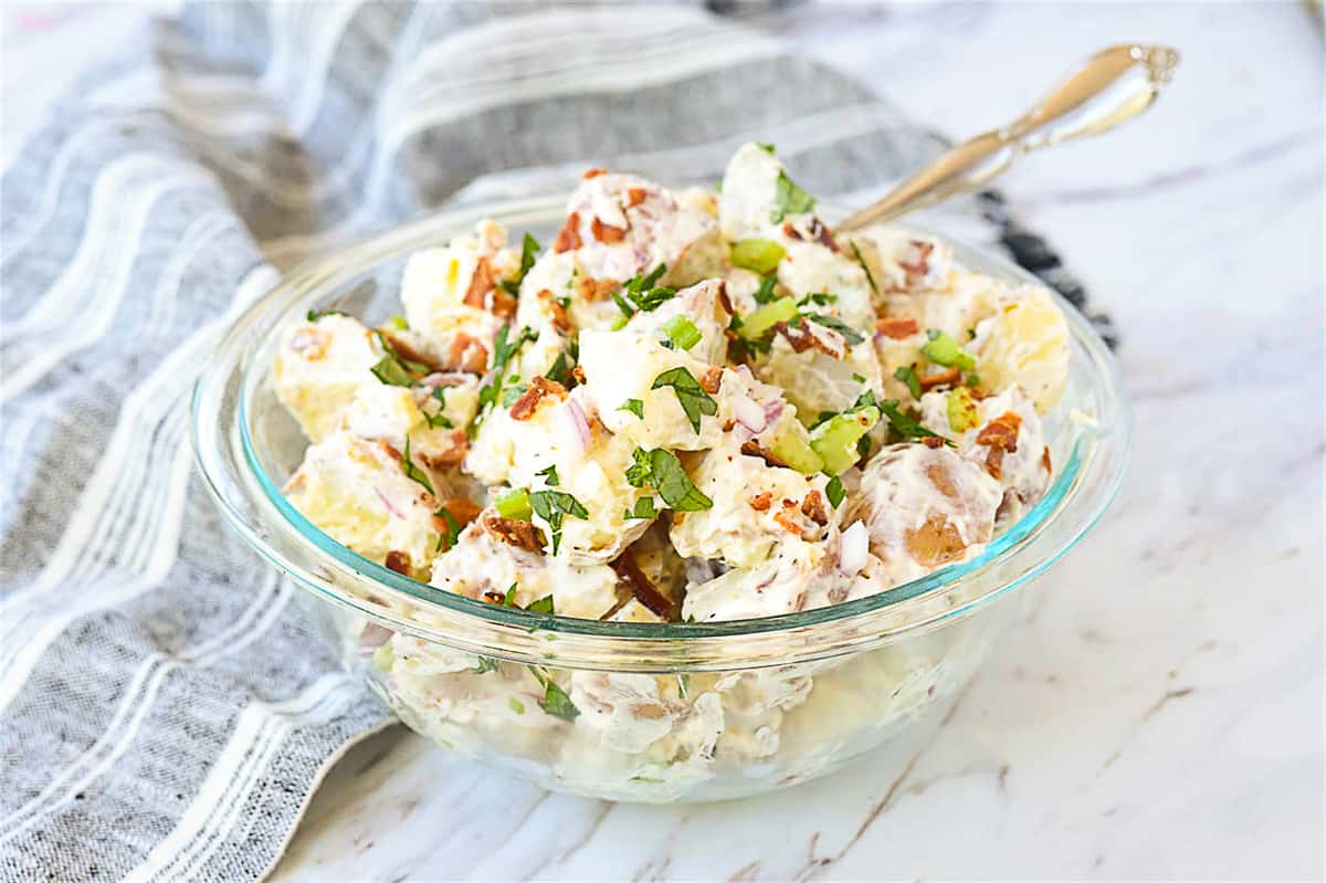 bowl of potato salad with a spoon in it