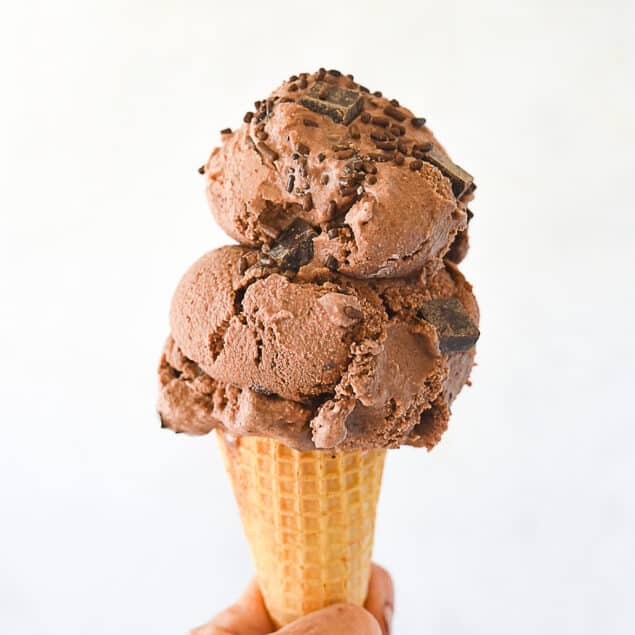 hand holding a chocolate ice cream cone