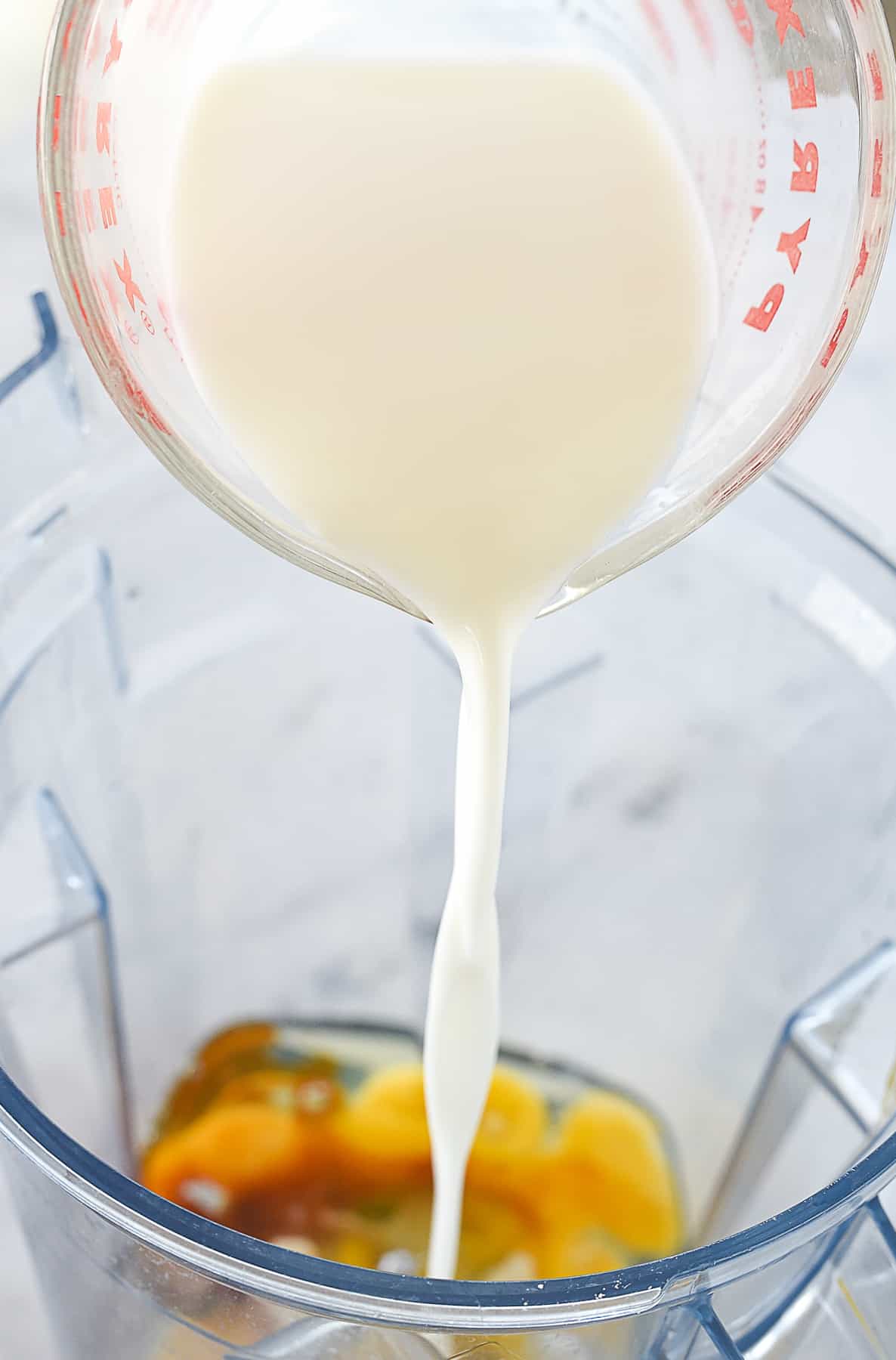 pouring milk into blender.