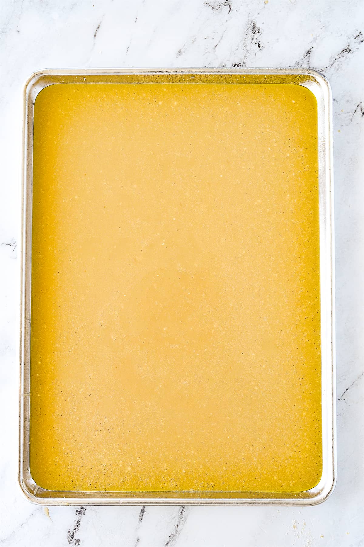 cake batter poured into sheet pan