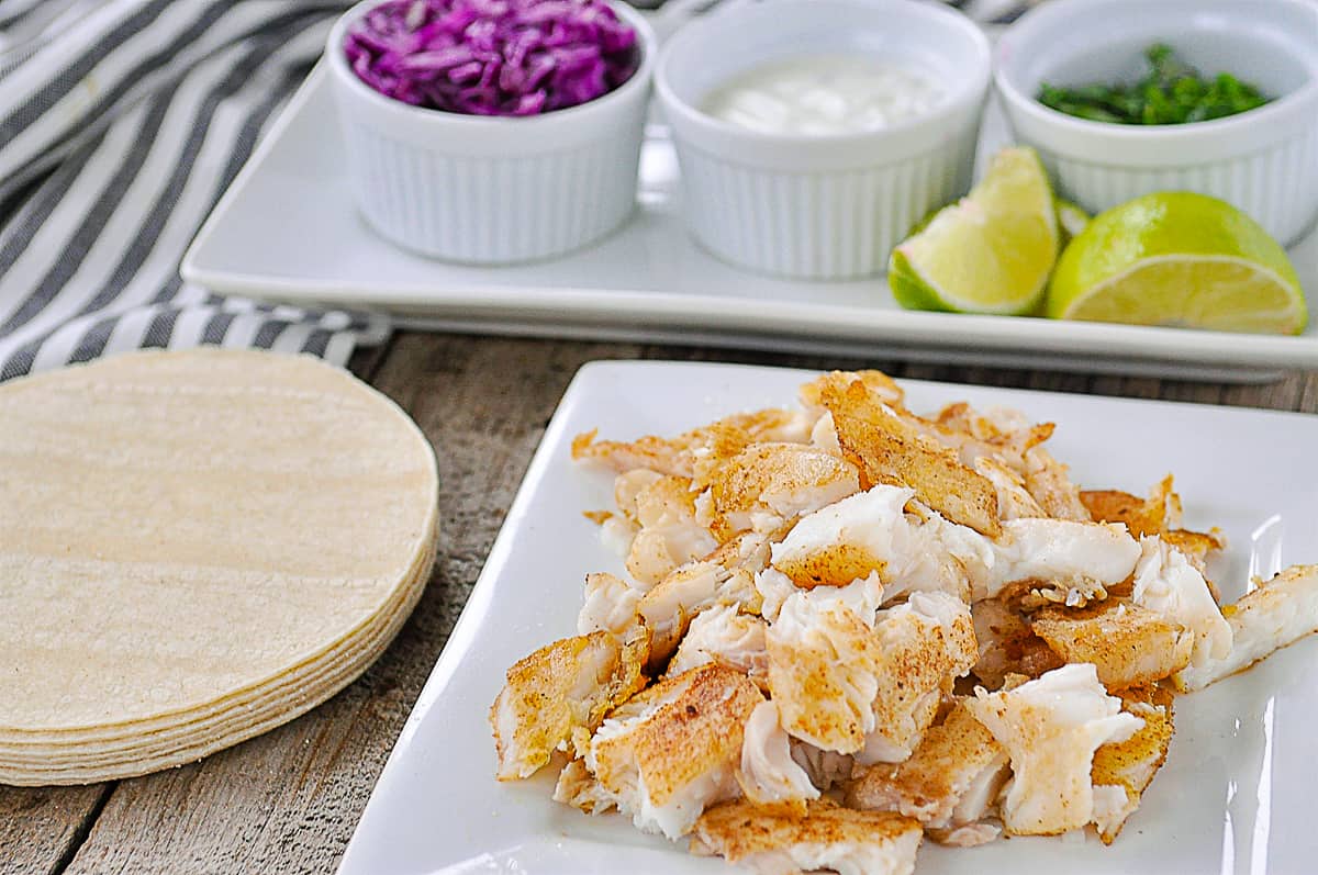 fish taco on a plate with toppings