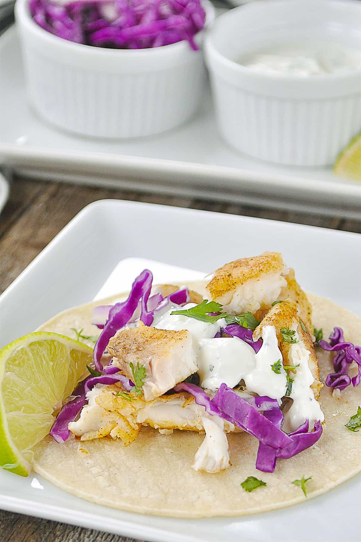 fish taco with fish taco sauce on top