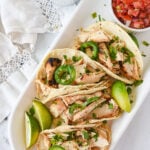 overhead shot of chicken tacos on a white plate