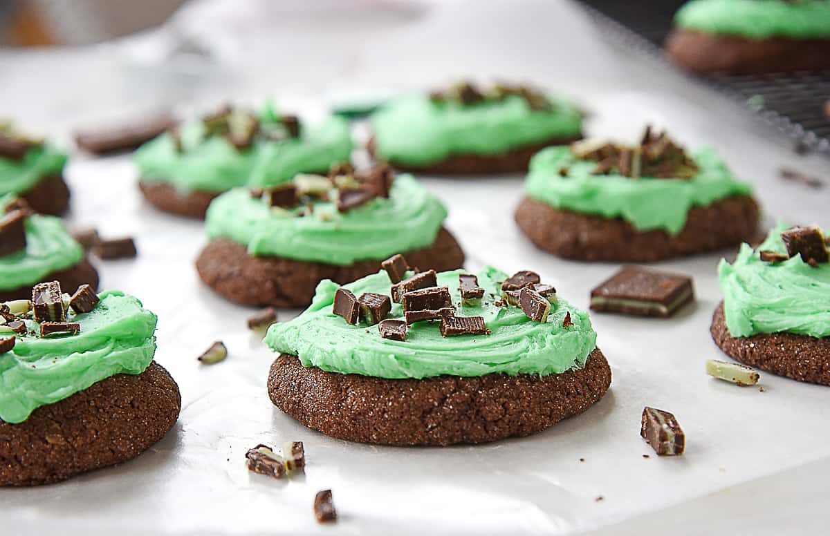 frosted mint chocolate cookies on wax paper