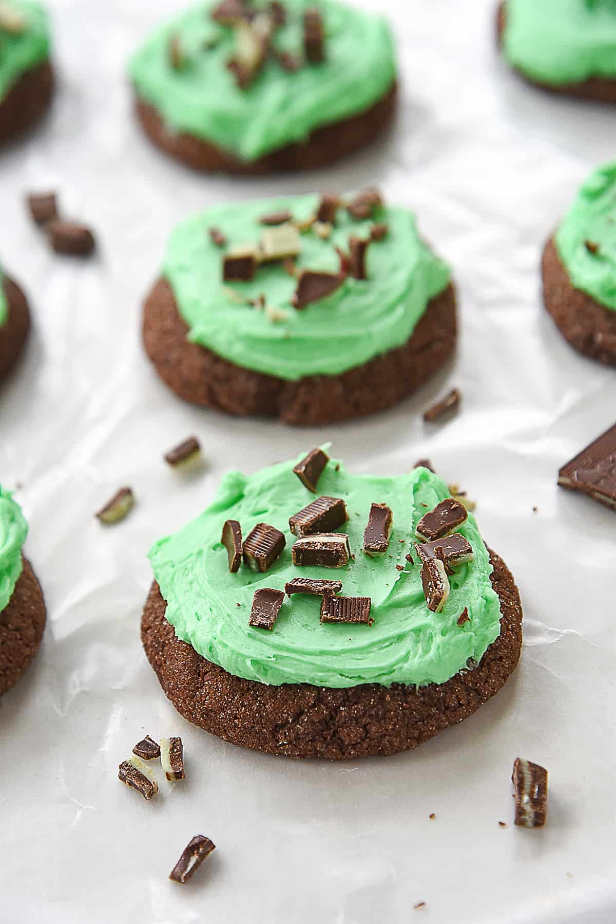 row of chocolate mint cookies with green frosting