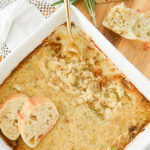 overhead shot of garlic artichoke dip in a white dish