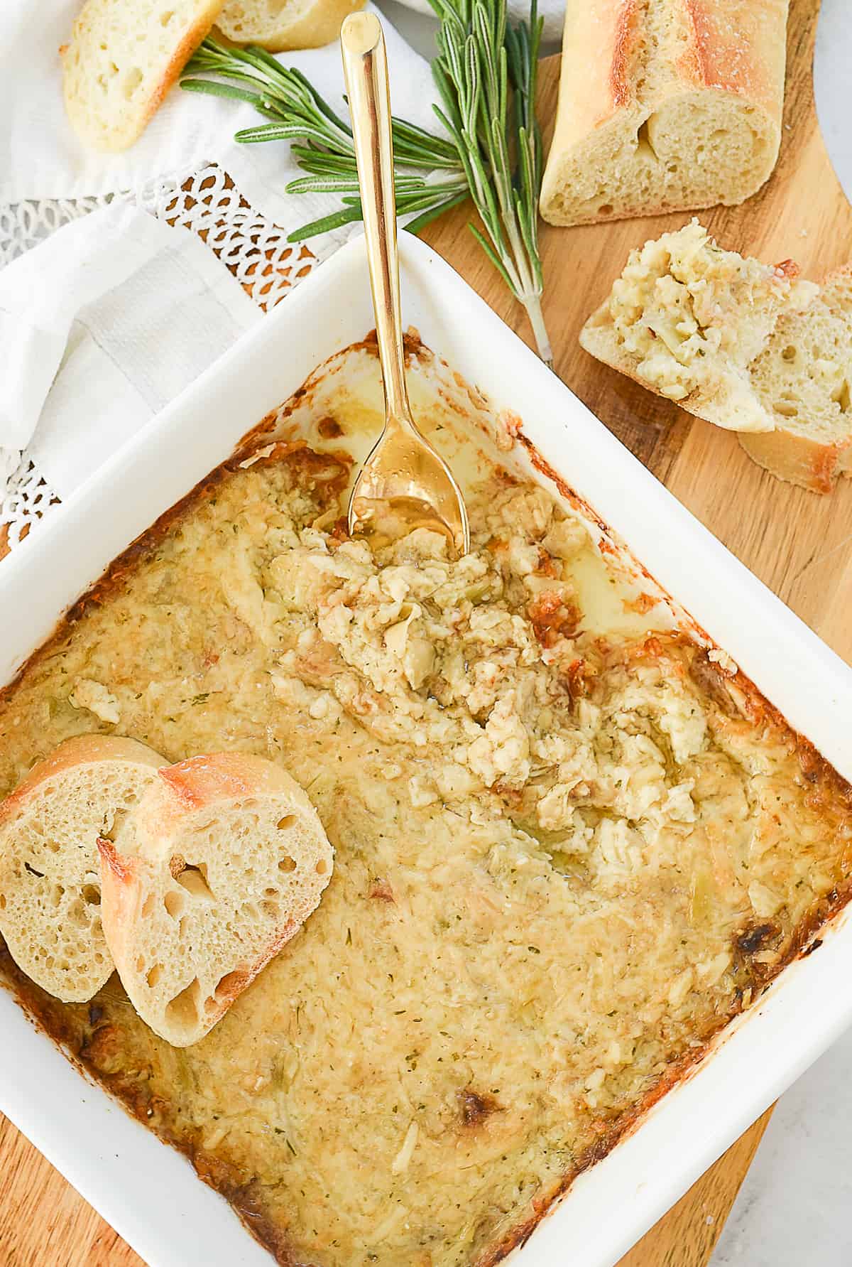 overhead shot of garlic artichoke dip in a white dish