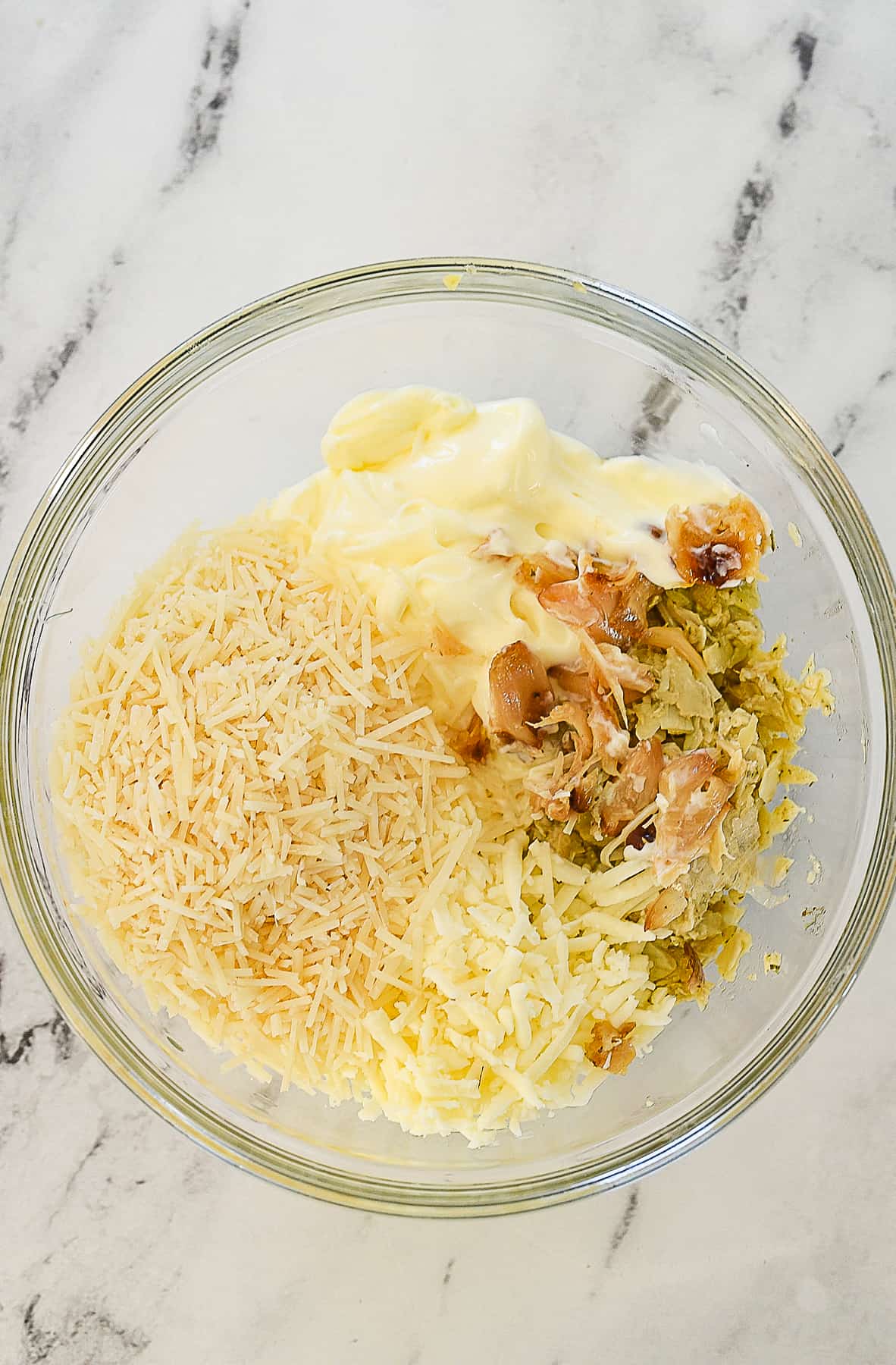 bowl of garlic artichoke dip ingredients