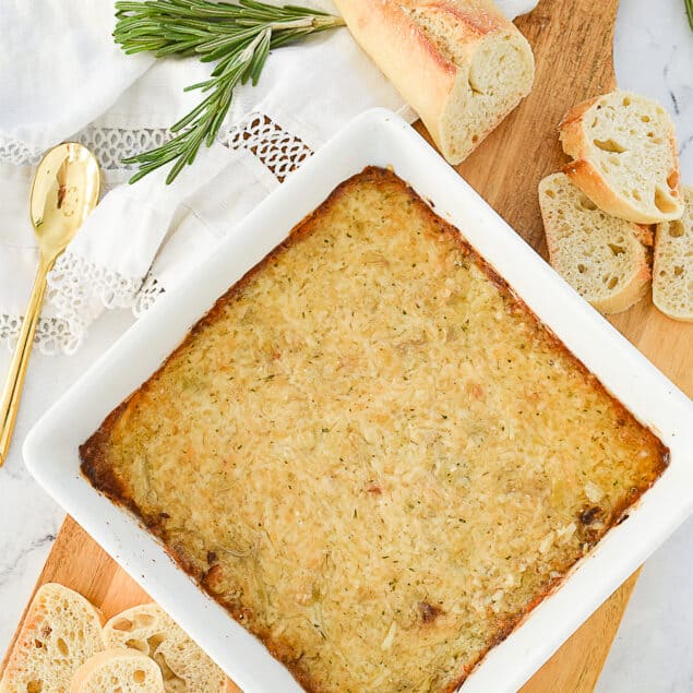 overhead shot of garlic artichoke dip in a white dish