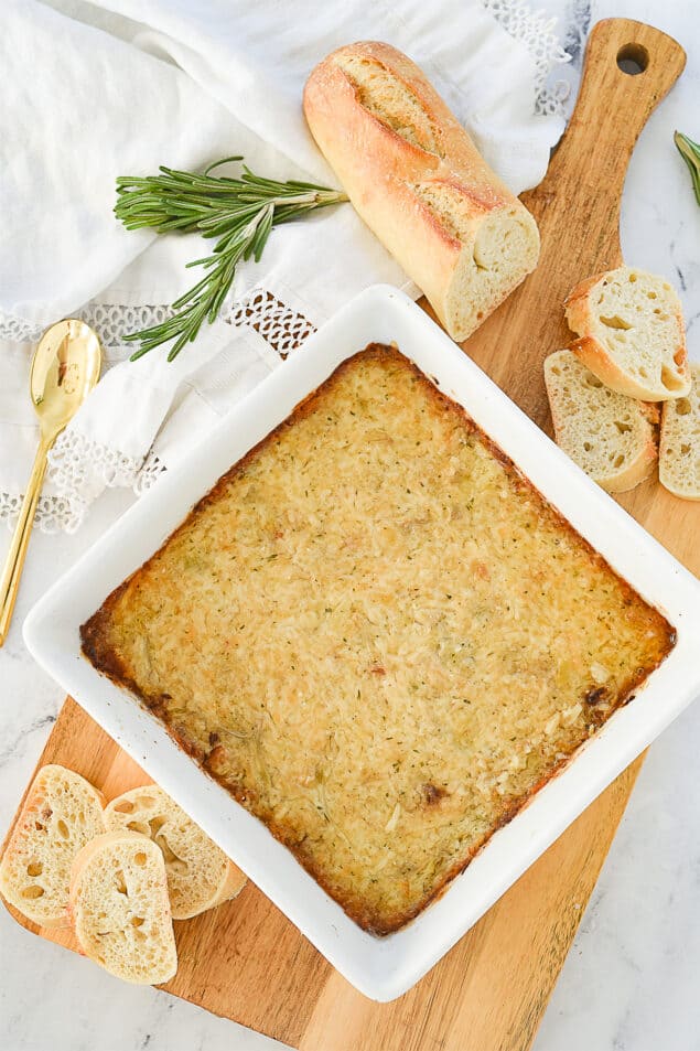 overhead shot of garlic artichoke dip in a white dish