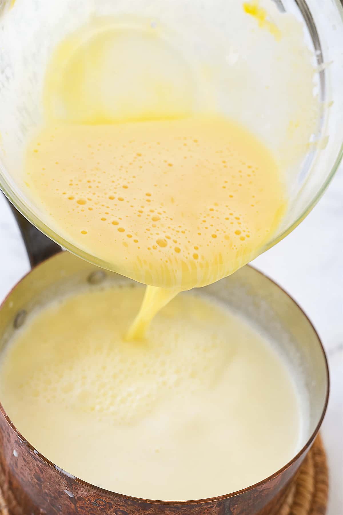 pouring egg mixture into pan