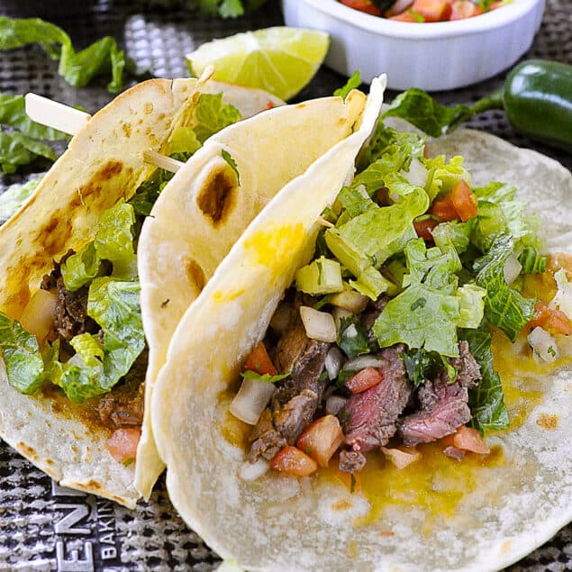 two steak tacos on a baking sheet