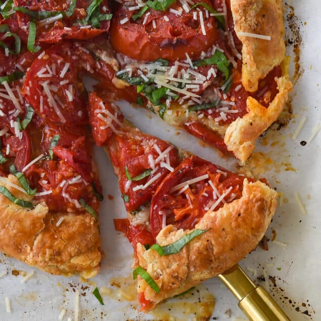 slice of tomato galette on a pie server