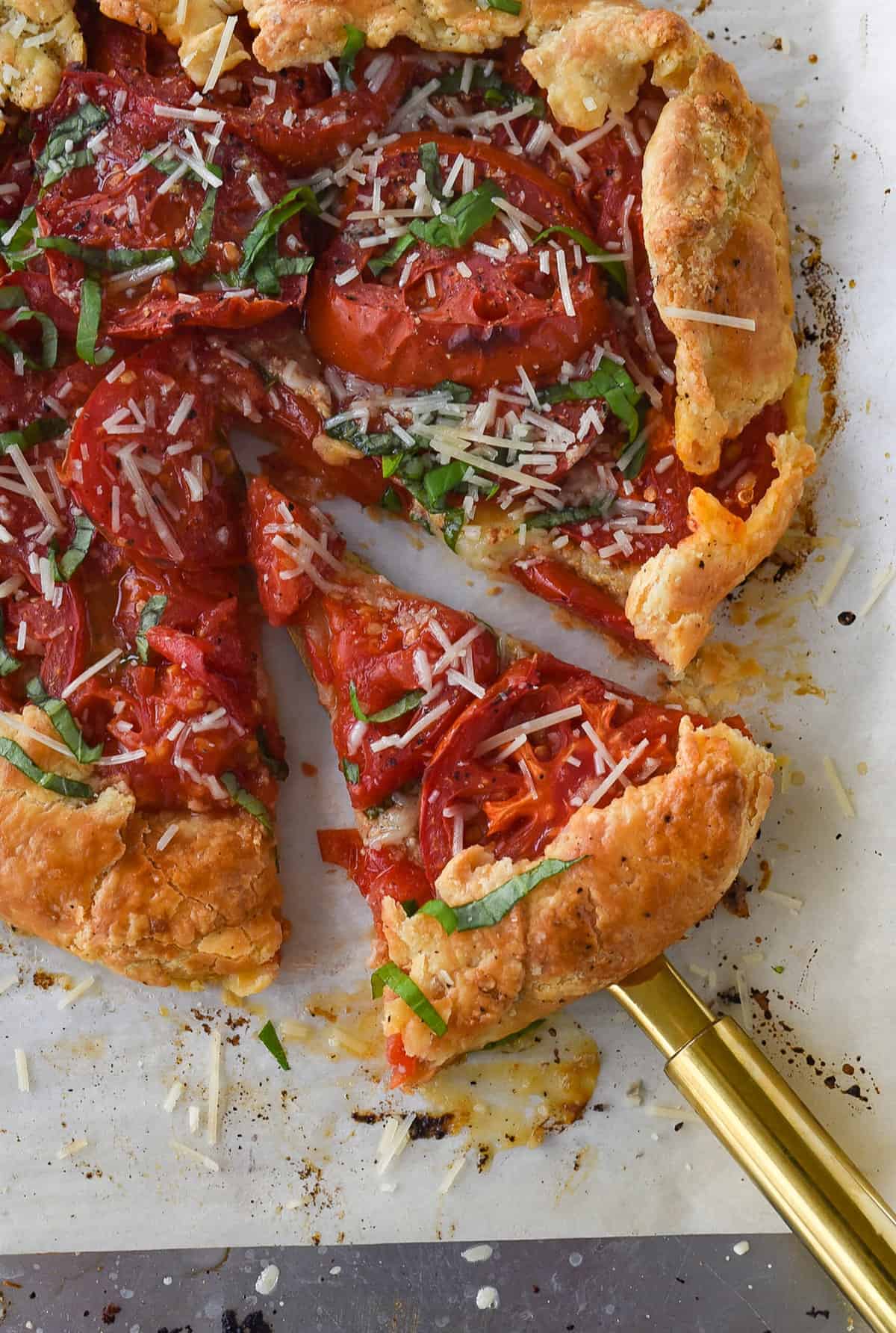 slice of tomato galette on a pie server