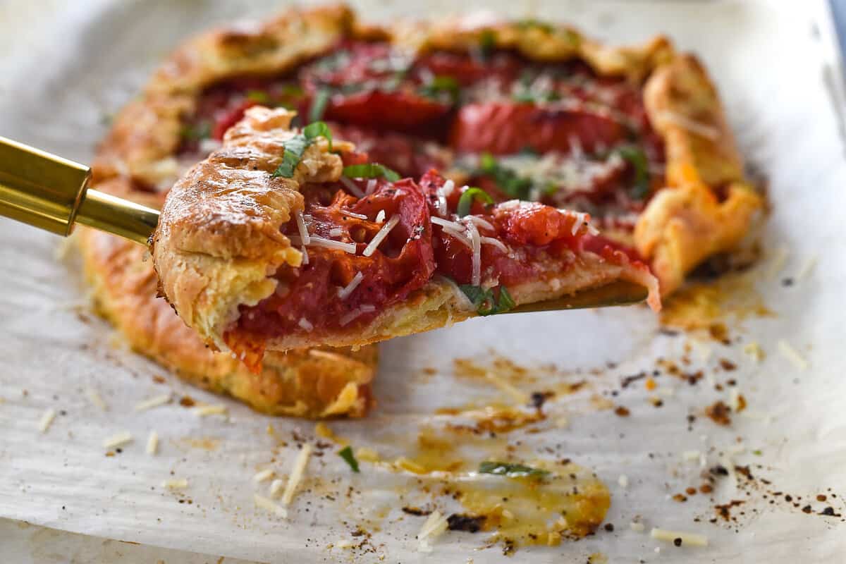 slice of tomato galette on a pie server