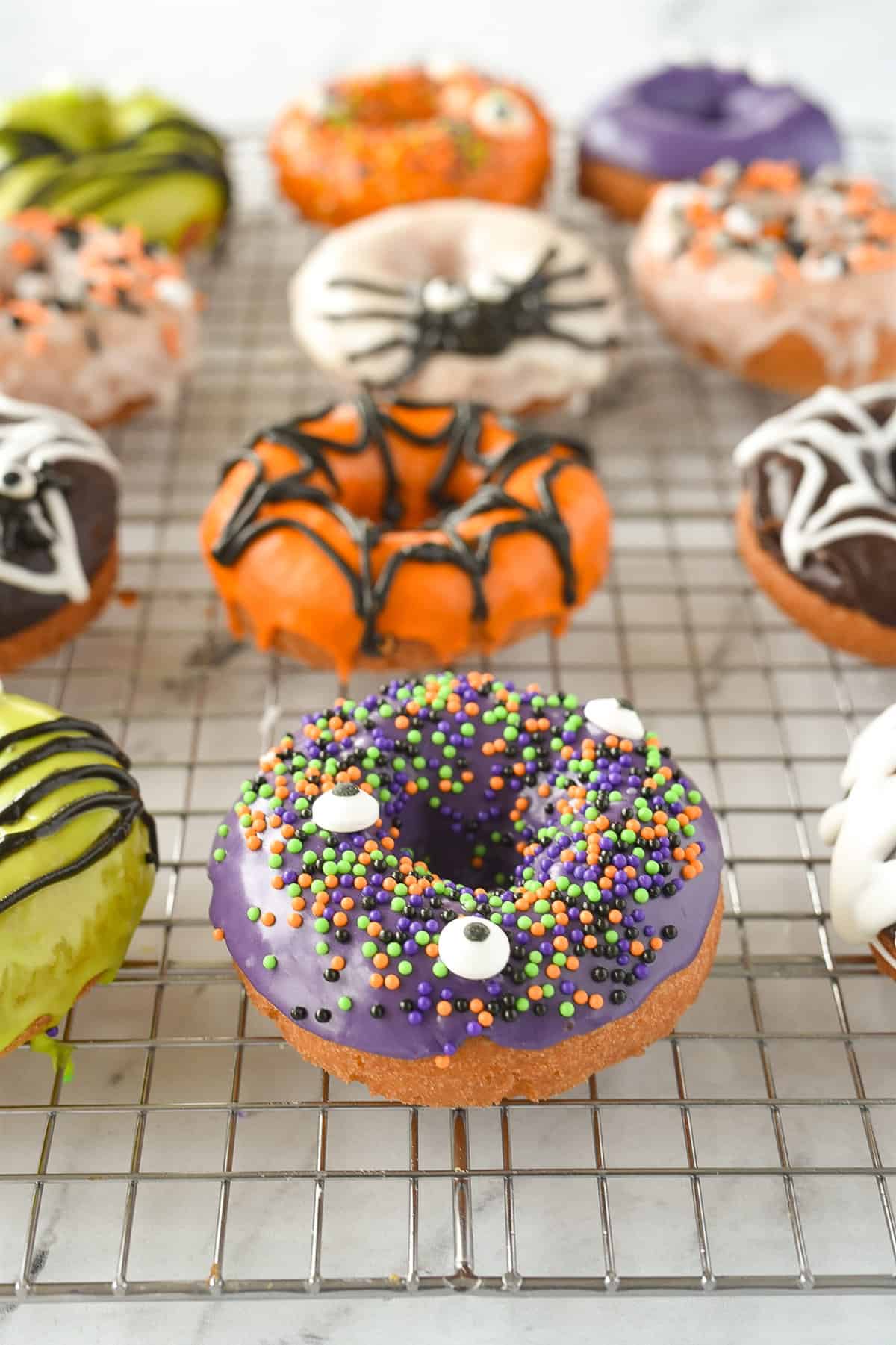 halloween donuts on a cooling rack
