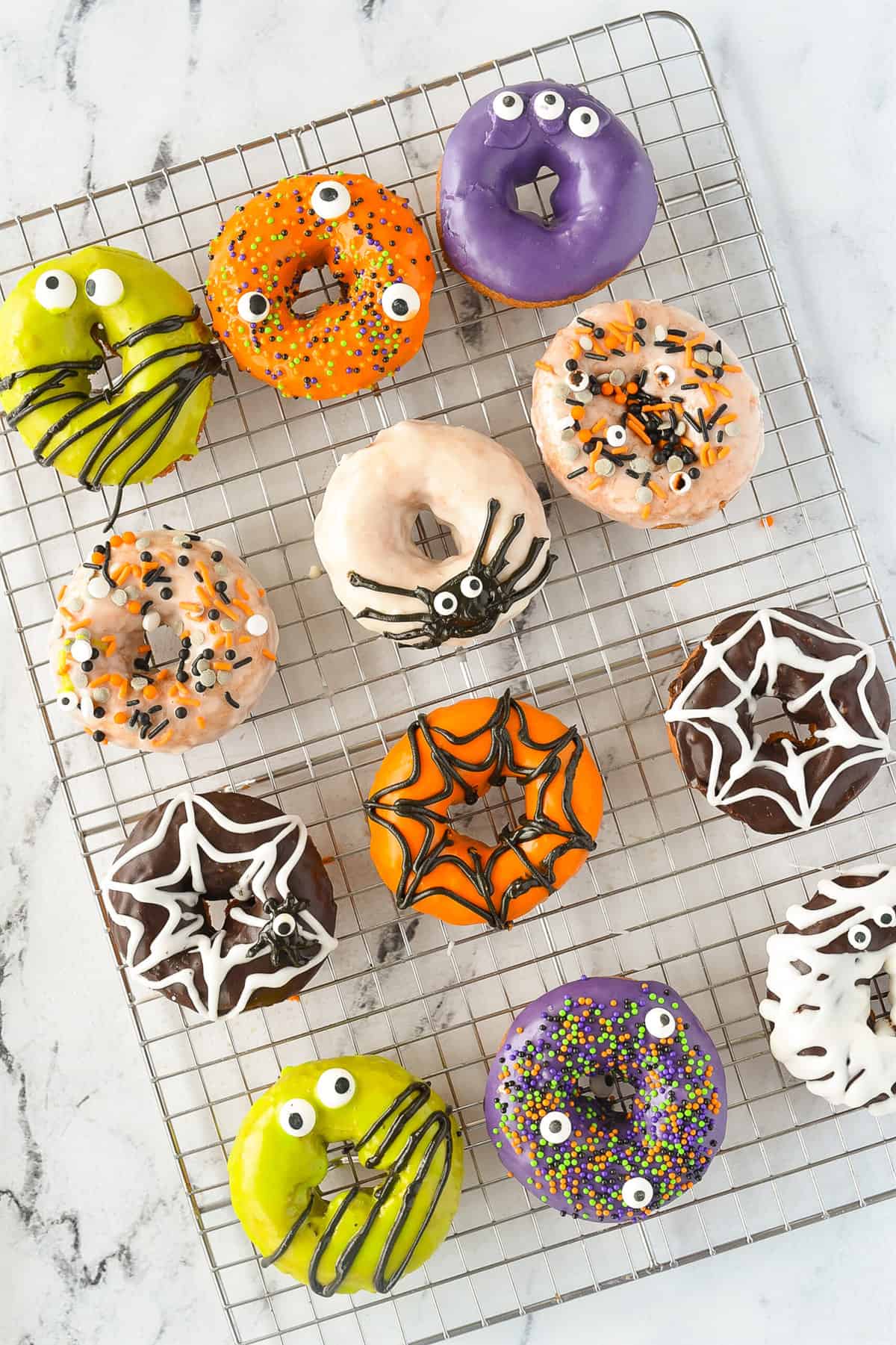 overhead shot of halloween donuts on a cooling rack