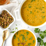 overhead shot of two bowls of curried butternut squash soup