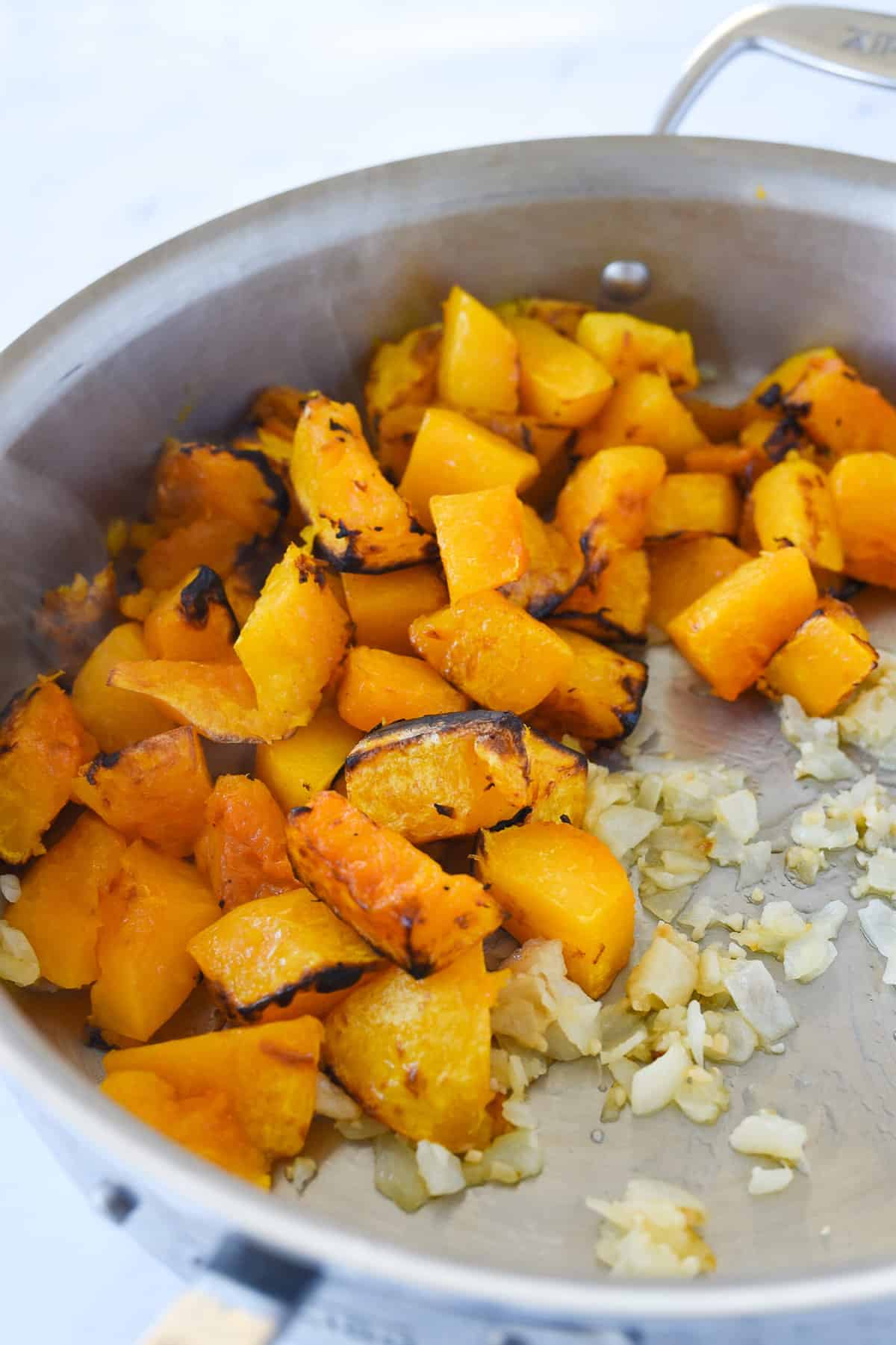 butternut squash and onions in a pan