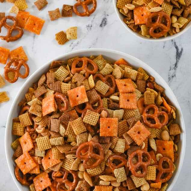 two white bowls of chex mix