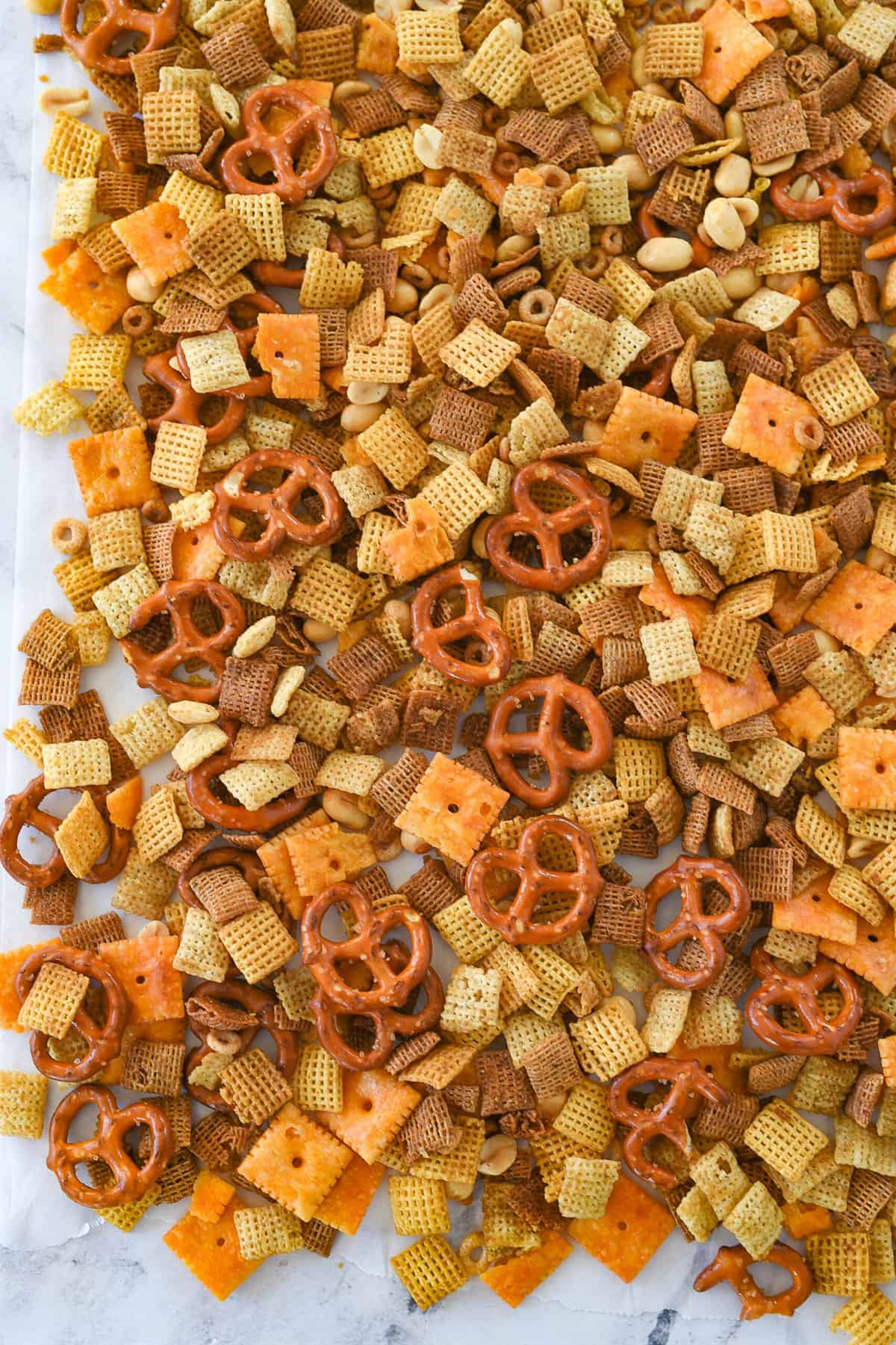 chex mix on parchment paper cooling