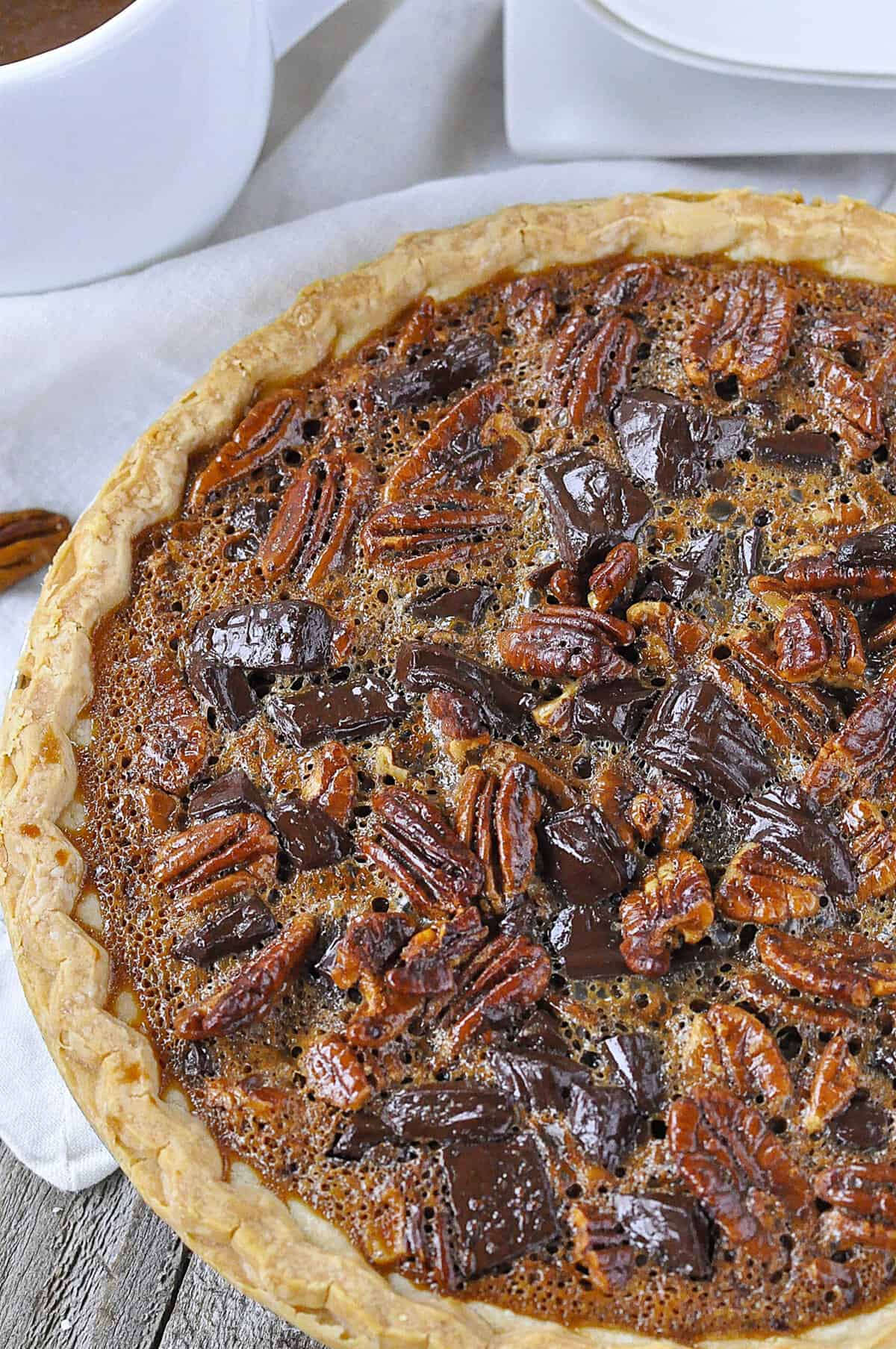 overhead shot of a whole chocolate pecan pie