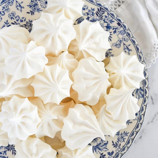 meringue cookies on a blue and white plate