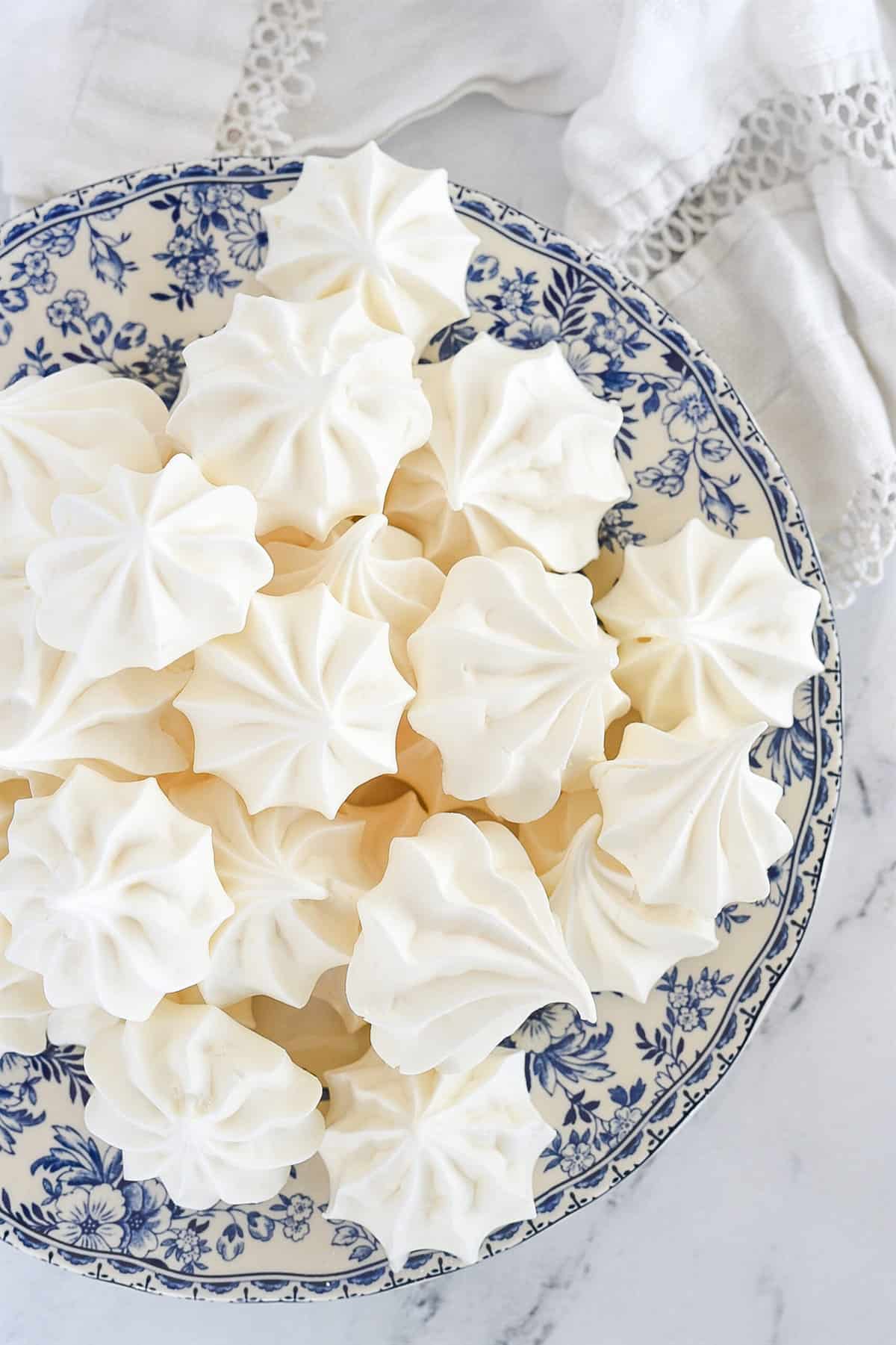 meringue cookies on a blue and white plate