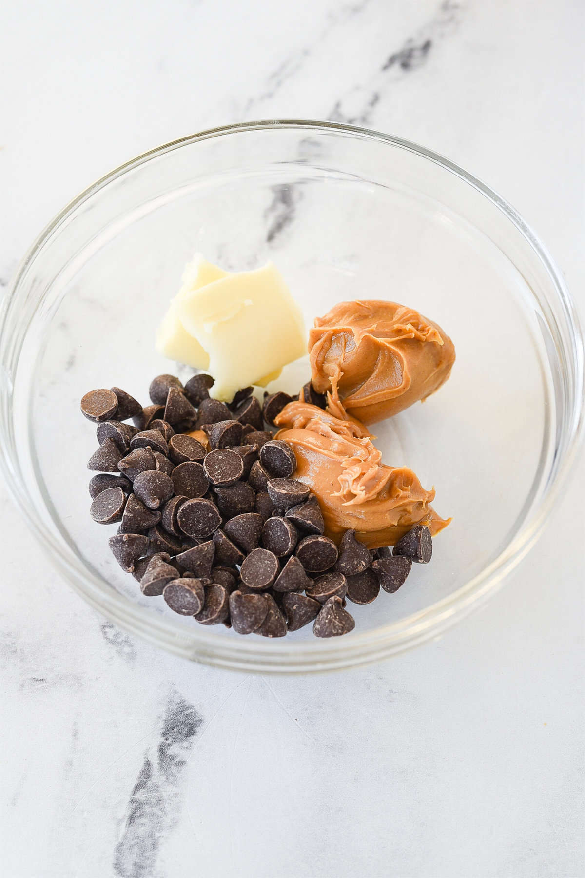 bowl with peanut butter, chocolate chips and butter

