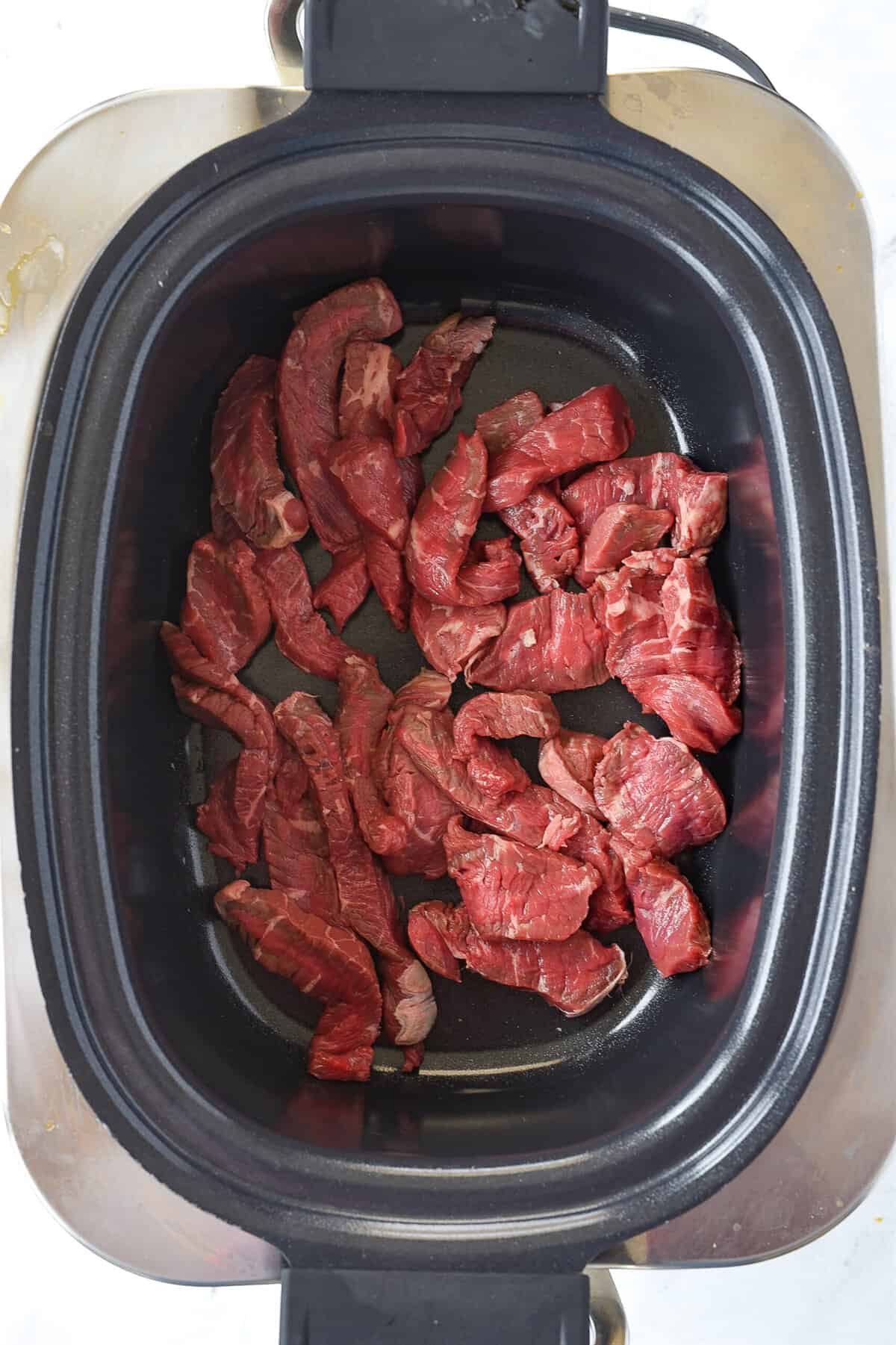 cut up steak in slow cooker

