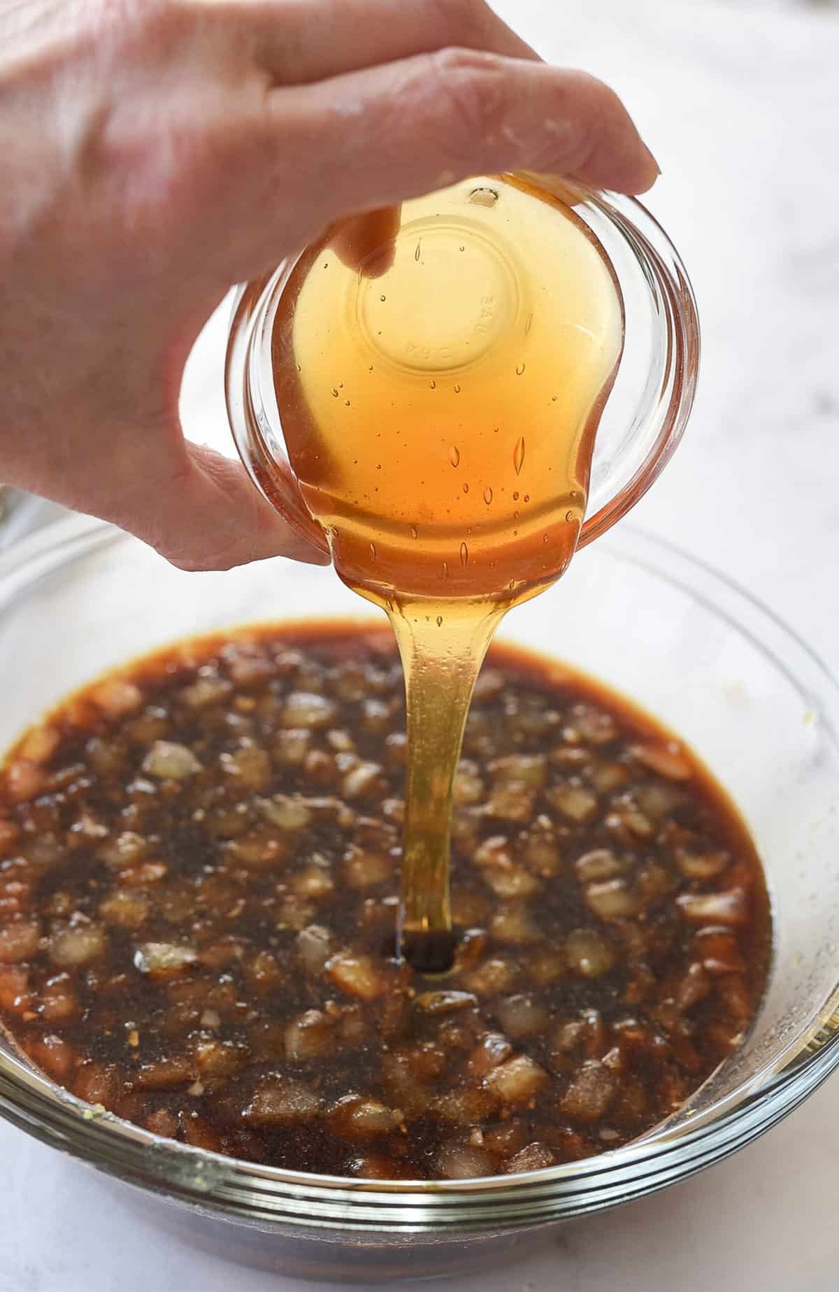 Pouring honey into a bowl