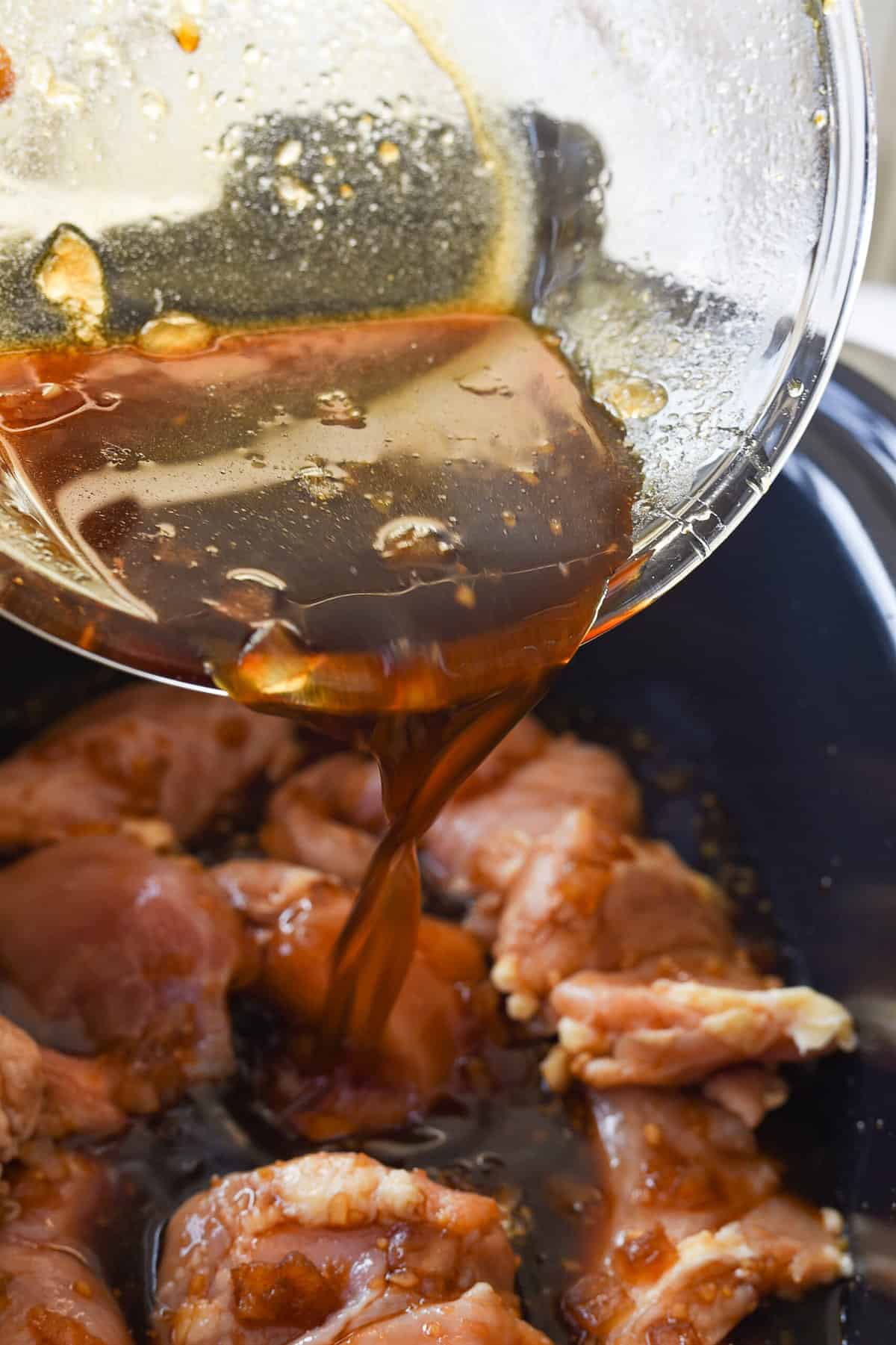 pouring marinade 
mixture over chicken